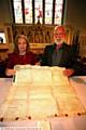 CELEBRATION . . . Hilary Saxon, of the church council, Stephen Whitehead, trustee of the Saddleworth museum, with the deed to the church from 1748, to the first curate of St John's, Richard Hopwood