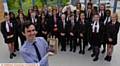 WINNER . . . Daniel Corrigan, head of music at Radclyffe School, with his Pearson Silver Award and the school choir