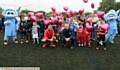 UNITED . . . Boxer Anthony Crolla and footballer Paul Scholes with youngsters release balloons at the football marathon at Curzon Ashton
