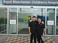 Paul Waterhouse (right with son Brandon Mason) visiting Manchester Children's Hospital to hand out get well soon cards and donations raised during Manchester Bee tattoo fundraiser at Paul's studio Forever-Inked