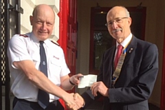 Jack Wild presents Roundthorn Salvation Army Lieutenant Jonathan Pitts with a cheque for £478