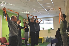 Aspect IT staff go through their yoga routine