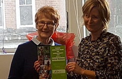 Anne Watson receives her award from Oxfam's Head of Retail Jane Randrup