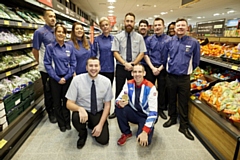 Etienne Stott MBE with the staff at the refurbished Aldi store