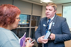 TfGM Chair, Councillor Mark Aldred, speaks to Geraldine Hills, whose son, Sam Hills, has benefitted from the training