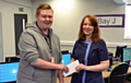 Rochdale Ear Clinic owner, Kath Scully, presents Kieran Cullinan with a gift reward for his website design