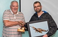 Oldham Camera Club chairman Phil Livesey presents the silverware to Martyn Brophy