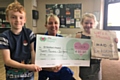 Harley Vickers and his friend Lily Coffey present a cheque to Dr Kershaw's Hospice