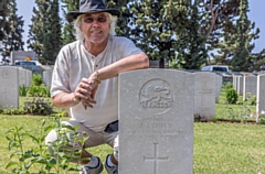 Michael Duffy at the grave of his grandfather, Oldhamer John James Duffy, in Greece