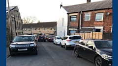 Cars overcrowding residential streets.