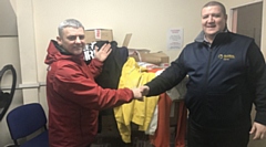 Marcel Duffy (right) hands over the tops and track suits