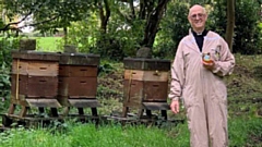 Rev Dr Halliday is pictured with a pot of the honey