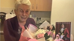 Mrs Smith is pictured with the mayor's birthday card and flowers