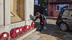 MP Debbie Abrahams pictured laying a wreath at the town centre memorial