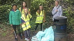 The five youngsters are pictured (left to right) with some of the rubbish: Amy Cummings, Millie Foster, Mary Brierley, Lola Simpson and Alice Winfield