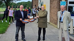 Jon Stocker is pictured with Helen Bishop and Rob Knotts, Rotary Club president