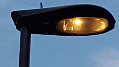 A streetlight burns energy during the daytime