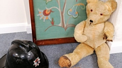 Some of the items donated, including a 1950s teddy, an original London fire brigade helmet and an embroidered picture