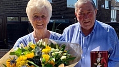 Heather and Barry Dunkerley with their flowers and card from the Mayor of Oldham, Councillor Ginny Alexander