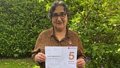 Marzia proudly holding her British Red Cross five years service certificate