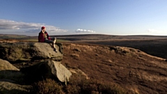 A walker takes a rest to admire the South Pennine's unique landscape