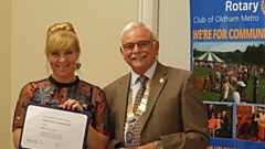 Jessica Moreland, President of Dovestone WI, receives the coveted honour from Garvin Crabtree, president of Rotary Oldham Metro