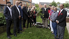 Cllr Elaine Garry, Mayor of Oldham (centre), is joined by guests to plant a magnolia tree at the Primrose Bank Community Centre to mark the Queen’s Platinum Jubilee