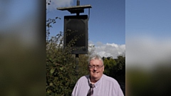 Councillor Howard Sykes pictured by a VAS sign on Buckstones Road