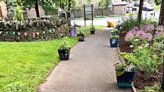 The village’s community garden featured pots decorated by school children containing sunflowers they had grown from seed