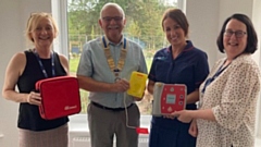 Pictured are Rotary President Garvin Crabtree presenting the defibrillator to Sarah Longmore at Dr Kershaw's, watched on the left by Joanne Sloan, Chief Executive, and Adele Doherty, Deputy Chief Executive and Director of Clinical Services.