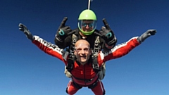 Dan Mounsey is pictured flying high with his parachute partner!