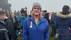 Julie Bradbury pictured with her father's cherished medal