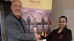 Saddleworth Rotary Club President Clint Elliott presents Angela Vyas from Yorkshire Air Ambulance with a cheque for £500 donation to the charity