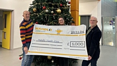 Saddleworth Rotary President Clint Elliott and Club Community Champion Jon Stocker are pictured presenting Mahdlo Events Lead Elizabeth Kershaw with a cheque for £1,000