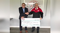 Chadderton FC Chairman Bob Sopel presents the £755 donation to Frank Rothwell
