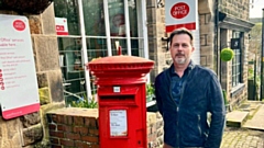 Nathan Beckwith pictured outside Dobcross Post Office and Village Store