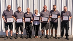 Some of the long-serving employees with their 25-year certificates, including Carole Hamnett-Sadler (centre)