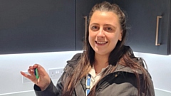 Charlotte Satchell-Higgins is pictured with her new home key