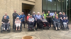 Sarah Tate, back row, third right, and fellow walkers at Broughton House, with staff and residents