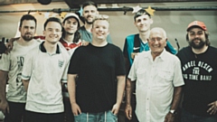 The Boundary Parkas are pictured with Oldham comedy icon Tommy Cannon