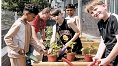 Children from a Mahdlo holiday club learn to grow and cook food in raised beds