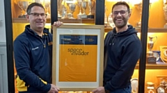 Former pupil John Williams (class of 1991, right) and founder of SpaceInvader is pictured with Hulme Grammar School Director of Sport Gus Hurst with this year's brand new football shirt