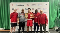 Champ Saul Griffith is pictured with head coach Eric Noi and the Oldham Boxing team