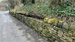 The scene as stones appear to have been removed from Gelfield Lane in the vicinity of Saddleworth parish church